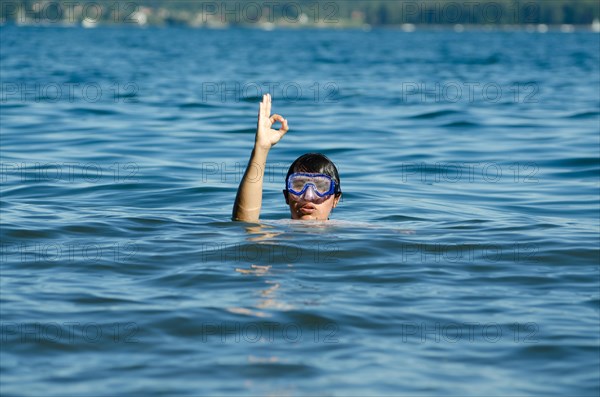 Woman with Diving Mask in the Water and Showing the OK Signal