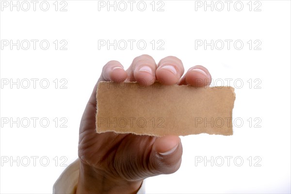 Hand holding a piece of blank torn notepaper