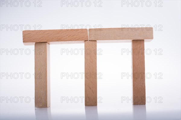 Wooden Domino Blocks in a line on a white background