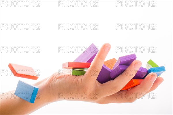 Falling colorful domino onto a hand