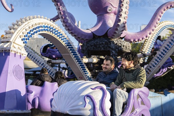 Couple of latin friends having fun in an amusement park