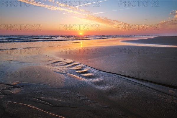 Atlantic ocean sunset with surging waves at Fonte da Telha beach