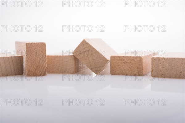 Wooden Domino Blocks in a line on a white background