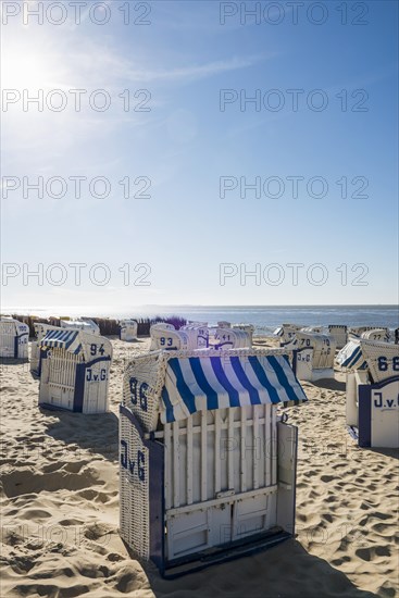 White beach chairs and mudflats