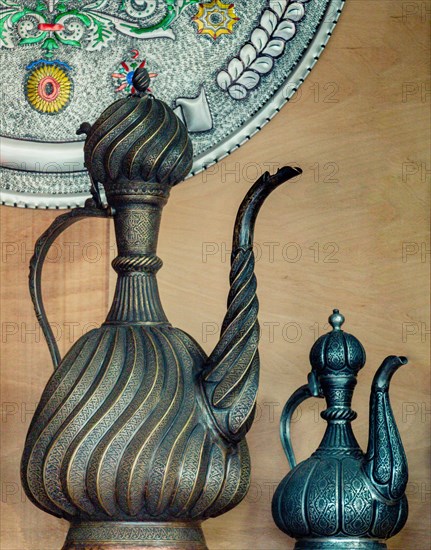 Ancient metal jug in oriental style in antique market