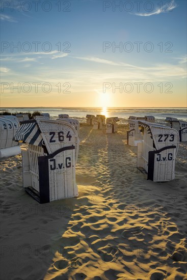 White beach chairs and mudflats