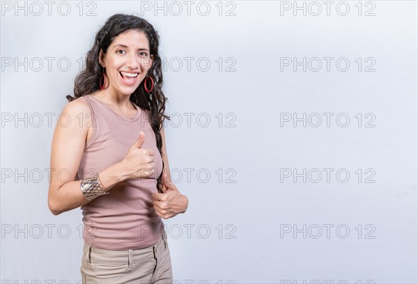 Happy smiling woman with thumbs up doing ok. Happy girl with thumbs up on isolated background