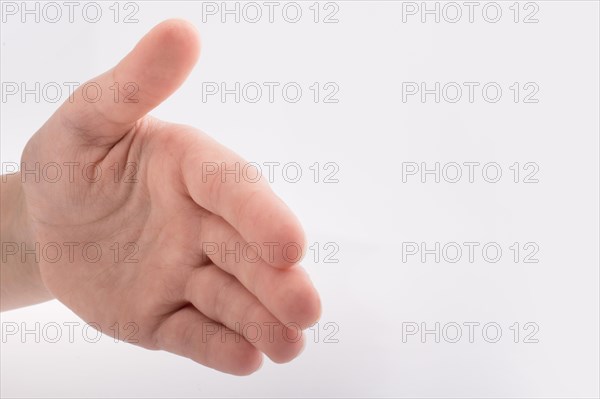 Hand shaking gesture made on a white background
