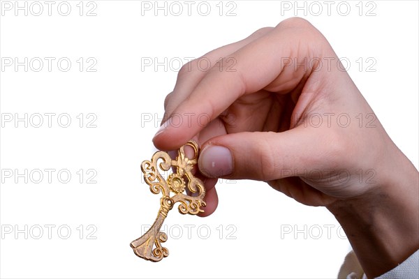 Hand holding a retro styled metal key on a white background