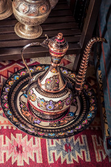 Ancient metal jug in oriental style in antique market