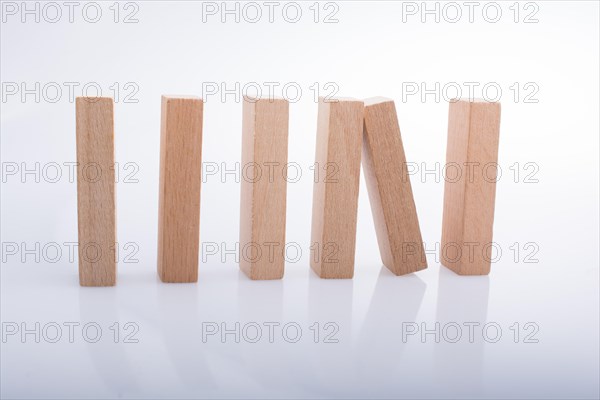 Wooden Domino Blocks in a line on a white background