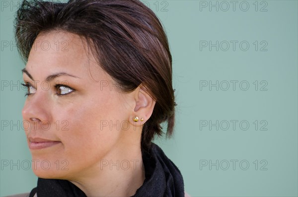 Headshot on a Self Confident Woman on Green Wall