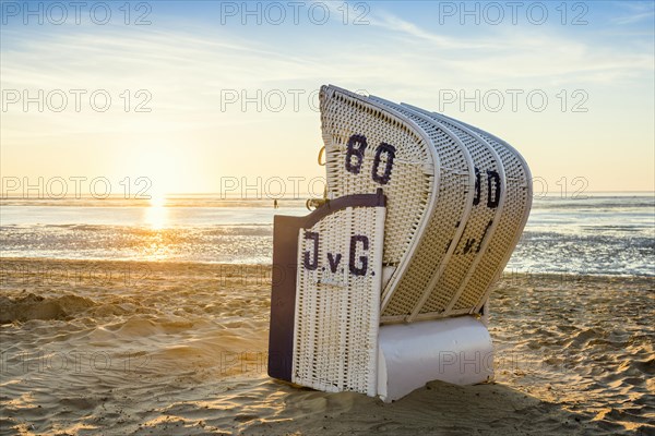 White beach chair and mudflats