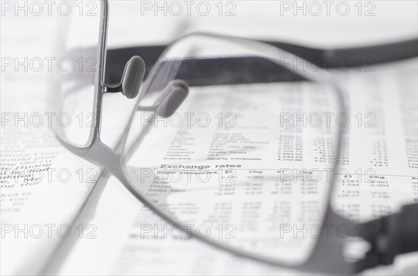 Financial newspaper and eyeglasses