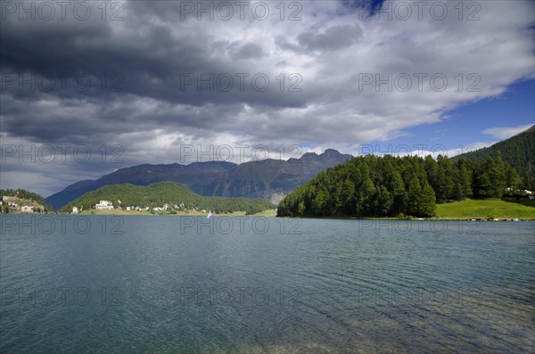 St Moritz Lake and Mountain and Green Trees with Grey Clouds in a Sunny Day in Switzerland
