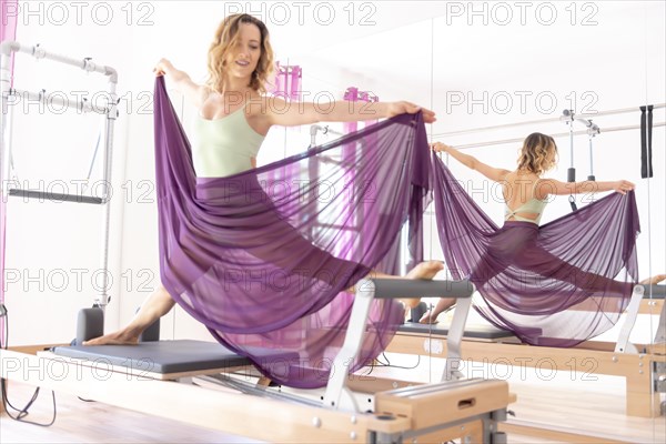 Woman Exercising on Pilates Machine with Transparent Skirt