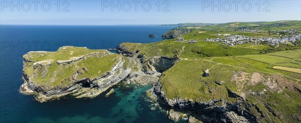 Aerial panorama of the rugged coastline on the Celtic Sea with the Tintagel Peninsula and the ruins of Tintagel Castle