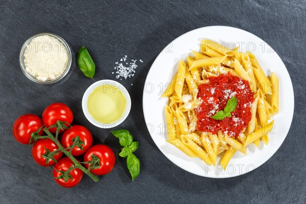 Penne Rigatoni Rigate Italian pasta in tomato sauce eat lunch dish on plate slate from above in Stuttgart