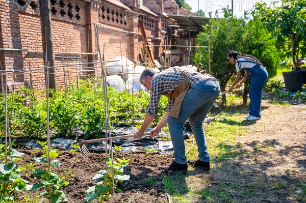 Master gardener teaching student girl in greenhouse flower nursery growing the seeds