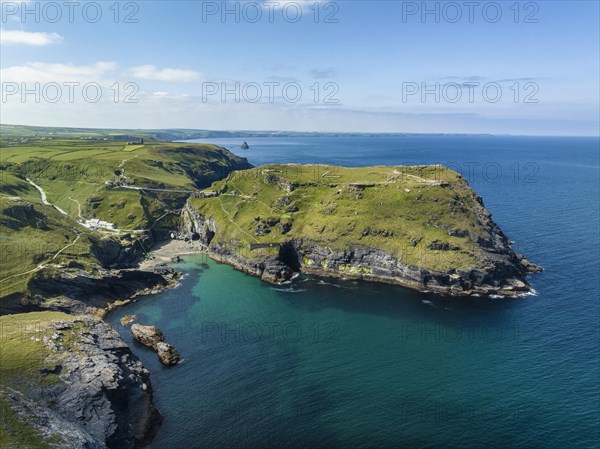 Aerial view of the rugged coastline on the Celtic Sea with the Tintagel Peninsula and the ruins of Tintagel Castle