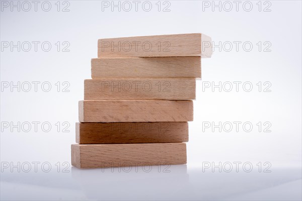 Wooden Domino Blocks in a line on a white background