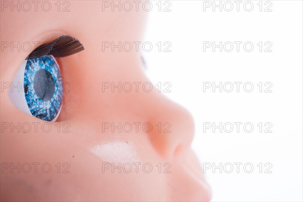 Baby doll's blue eyes on a white background