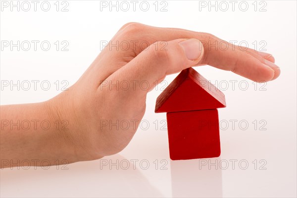 House made of colorful cubes in hand on a white background