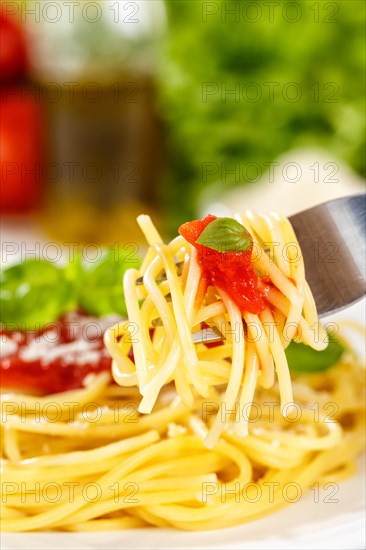 Eat spaghetti with fork Italian pasta lunch dish with tomato sauce in Stuttgart