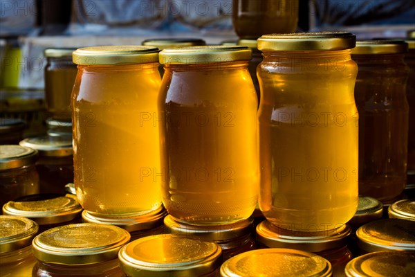 Glass jar of full of fresh honey with lid