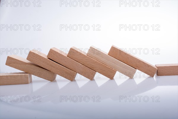 Wooden Domino Blocks in a line on a white background