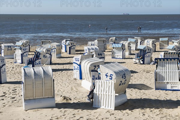 White beach chairs and mudflats