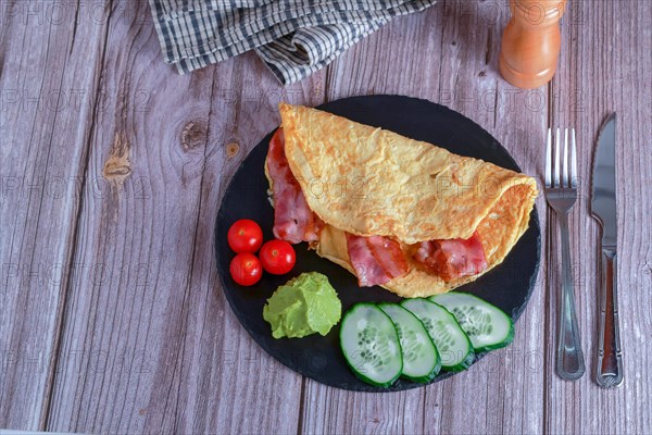 Bacon stuffed omelette with cucumber