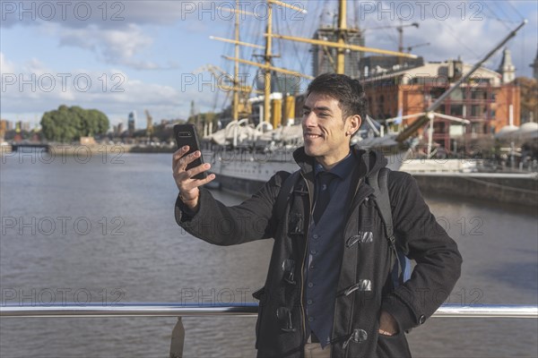 Happy tourist taking a selgie in Puerto Madero