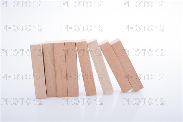 Wooden Domino Blocks in a line on a white background