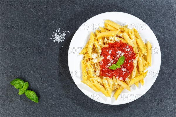 Penne Rigatoni Rigate Italian pasta in tomato sauce eat lunch dish on plate slate from above in Stuttgart