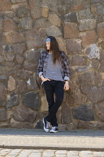 Young long-haired man in plaid shirt