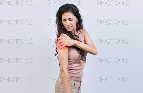 Woman with shoulder and arm pain on isolated background. Sore young woman with arm pain isolated. Woman suffering with arm pain