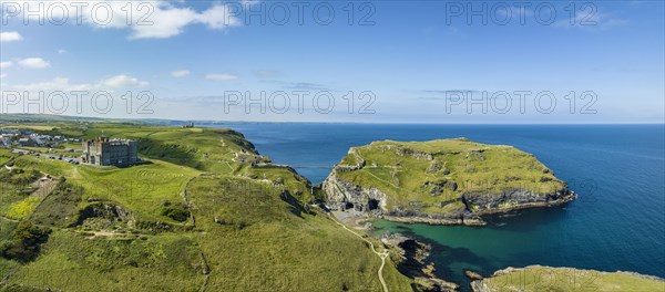 Aerial panorama of the rugged coastline on the Celtic Sea with the Tintagel Peninsula and the ruins of Tintagel Castle