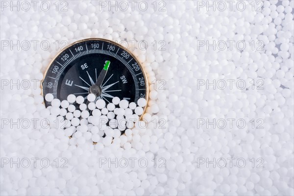 Compass on little white polystyrene foam balls