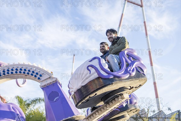 Couple of latin friends having fun in an amusement park