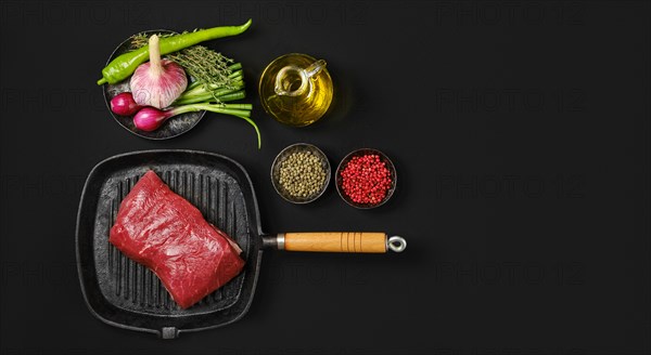 Top view of top round beefsteak on cast iron skillet