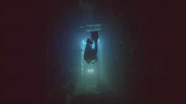 Scuba diver swim inside of ferry Salem Express shipwreck