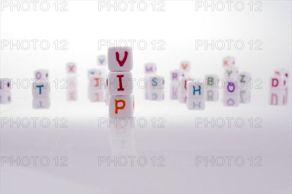 Alphabet blocks and the word VIP on a white background