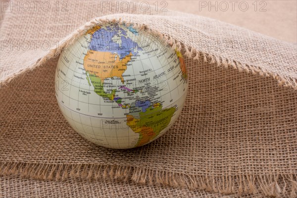 Model globe placed under a linen canvas