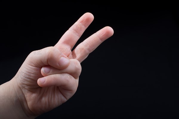 The sign of victory and peace in black background