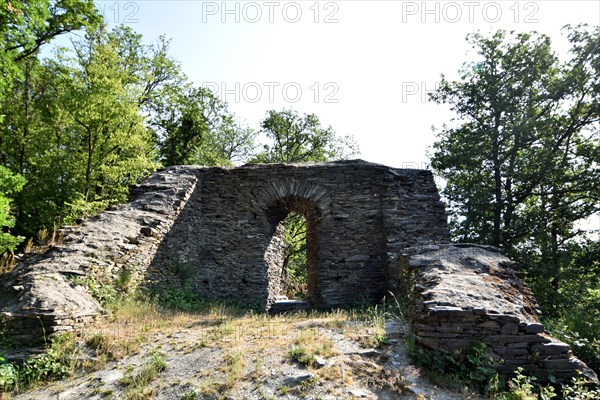 The 14th-century Hellkirch ruin built of slate on a rocky spur above the Hahnenbach valley near Woppenroth in Hunsrueck