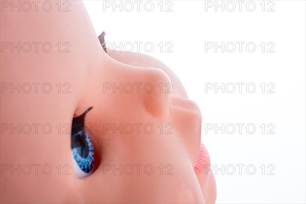 Baby doll's head on a white background