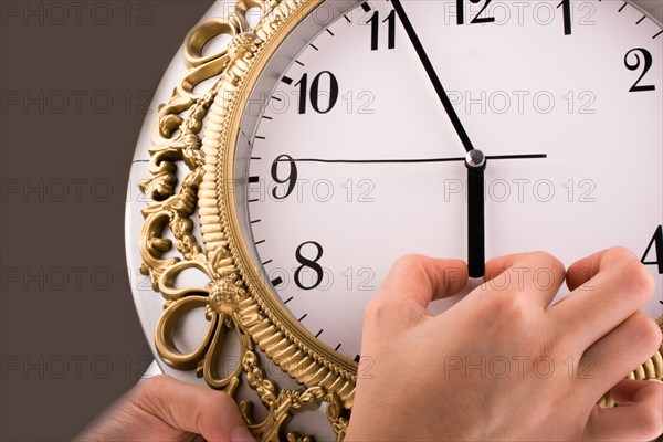 Hand in touch with a clock on a white background