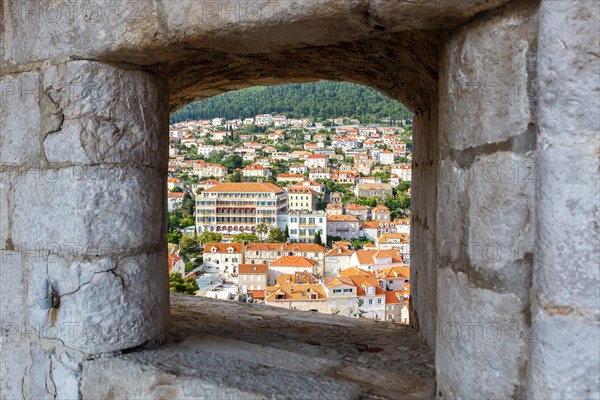 View of the old town through an opening in the wall of the fortress in Dubrovnik