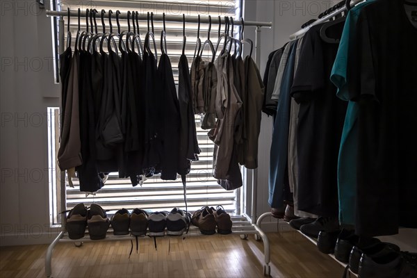 Clothes Hanger on Rack and Shoes Against a Window with Blinds in Switzerland